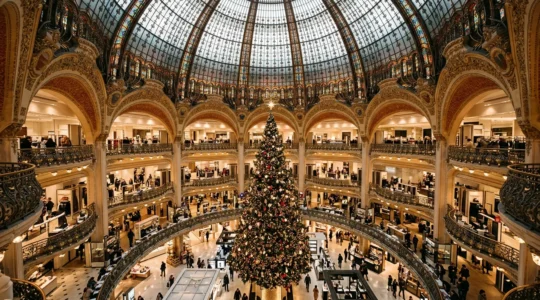 Panoramic view of Galeries Lafayette during Christmas season showing festive decorations and shoppers